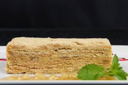 Esterhazy traditional cake on a white plate with mint