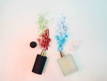 Flat lay composition with two perfume bottles with sparkles on paper backgroundの写真素材