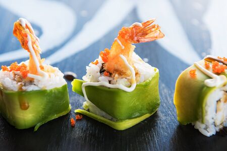 Various kinds of sushi served on wood black table.の写真素材