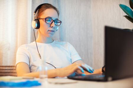 Woman in quarantine for coronavirus covid-19 working from home. Protective mask and Sanitizer spray...