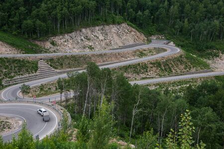 Winding road in the mountains, drone shot. Altai Krai, Western Siberia, Russia. Road to Resort town...