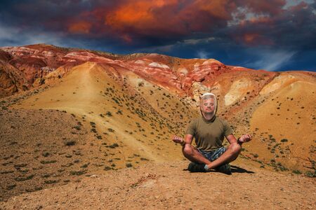 Man in mask on mars landscape with beauty sky sunsetの写真素材