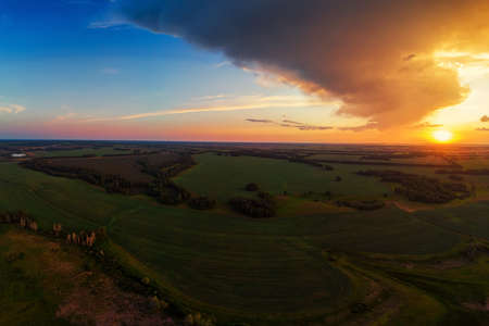 Aerial view on the field during sunset. Agricultural landscape from drone.の写真素材
