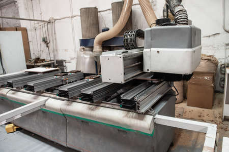 Wooden furniture production. Industrial machine for automatic wood drilling the mounting holes