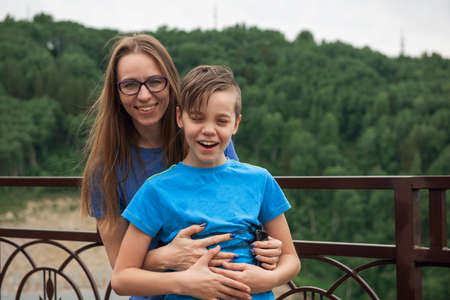 Portrait of happy laughing woman and her sun outdoor, quarantine summer. Concept of vacation at home, local tourism or domestic tourismの写真素材