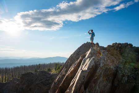 Domestic tourism, travel, lesure and freedom concept after pandemic- woman on the top of Altai mountain, beauty summer evening landcapeの写真素材