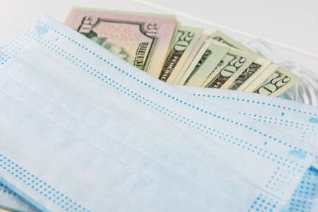 Sell - buy medical face mask concept. Protective face masks and nany US dollars banknotes