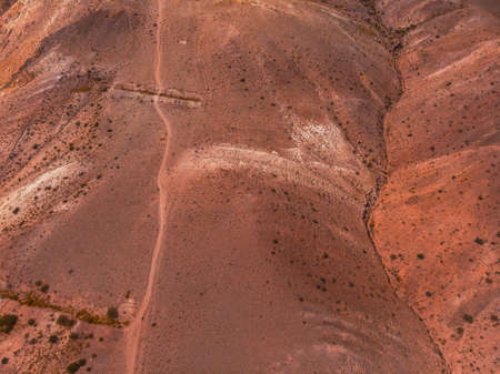 Aerial drone view of colorful eroded landform of Altai mountains with yellow, brown and red colors. Nature landscape in popular tourist location called Mars, near the border with Mongolia, Chagan-Uzun, Altai Republic, Russiaの写真素材