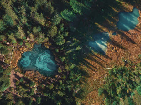 Beautiful Geyser lake with thermal springs and two small lakes nearly. Aerial drone view. Aktash, Altai mountains, Russiaの写真素材