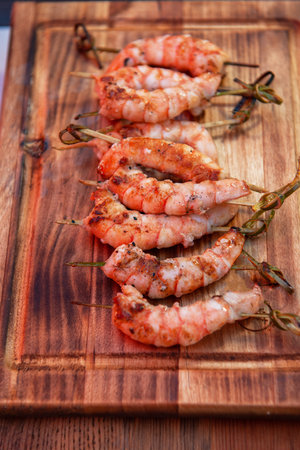 A professional cook prepares shrimps on the grill outdoor, food or catering conceptの写真素材