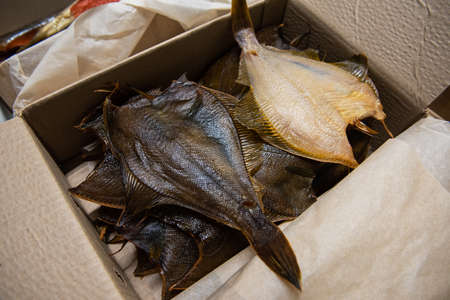 Smoked fish in craft paper box.の写真素材