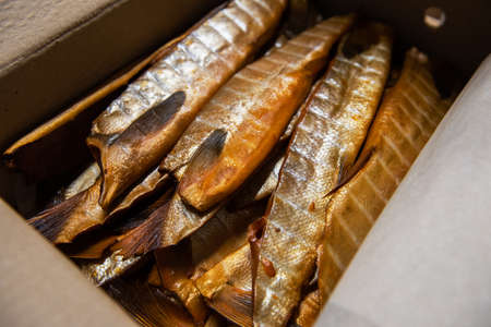Smoked fish in craft paper box.の写真素材