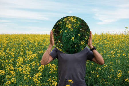 Man standing in yellow flowersの写真素材