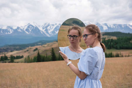 Woman in blue dress in summer Altai mountains