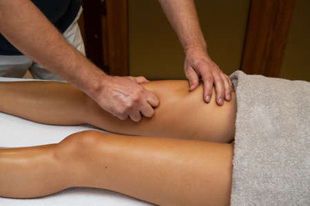 Woman getting legs massage in spa salonの写真素材