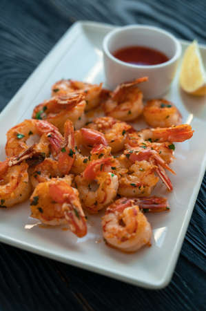 Fried shrimps with greens and saltの写真素材