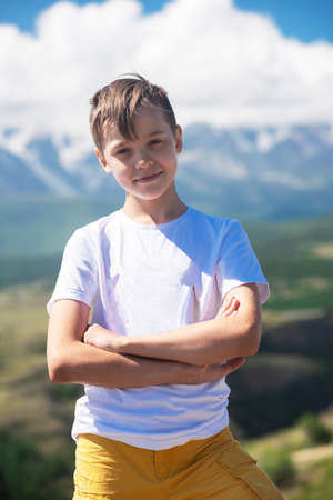 A child funny boy on the Altai mountain background.の写真素材