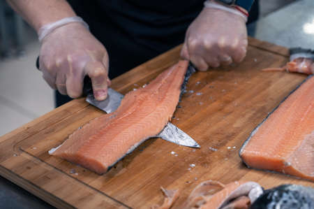 Chef preparing a salmon fishの写真素材