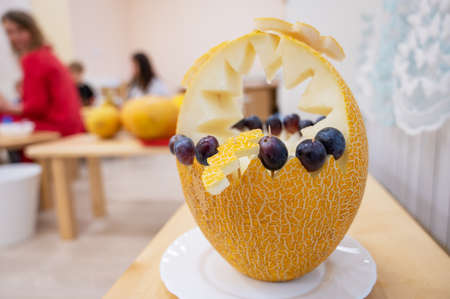 Female hands cutting pumpkin to halloweenの写真素材