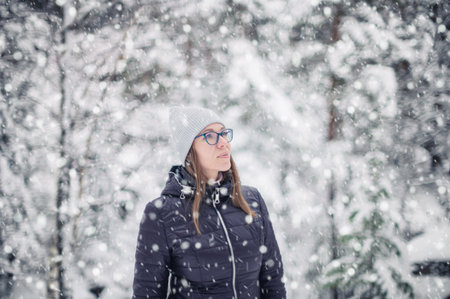 Woman walking in snowy winter forestの写真素材