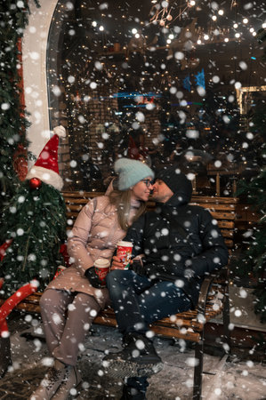 Happy kissing couple with fir tree decorated.の写真素材