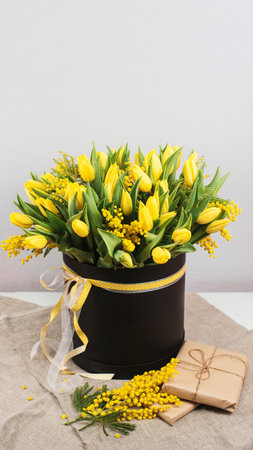 Bouquet of yellow tulips and mimosa flowersの写真素材