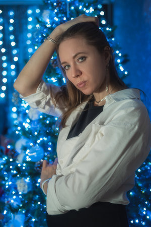 Happy woman posing on firtree backgroundの写真素材
