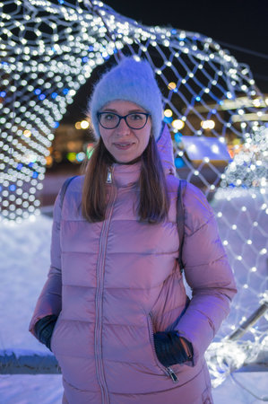 Pretty woman waking in New Year night cityの写真素材