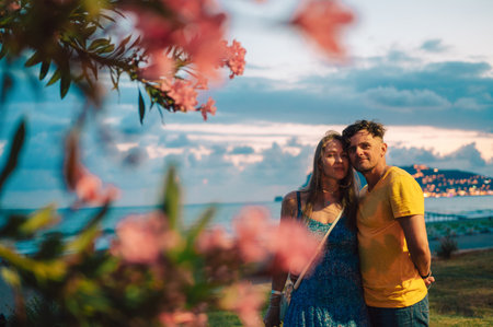Happy couple taking a photo on a beachの写真素材