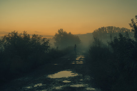 Woman in beautiful misty fog, summer landscapeの写真素材