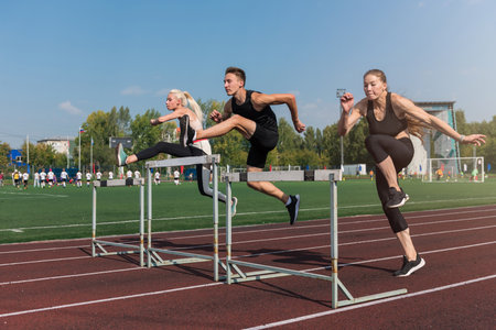 Two athlete woman and man runnner running hurdlesの写真素材