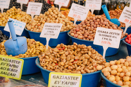 Different olives sale in the traditional farm Turkish market, a counter filled with fresh fruitsの写真素材