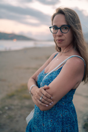 Woman sits on the beach and looks at the sea. Traveling or vacation conceptの写真素材