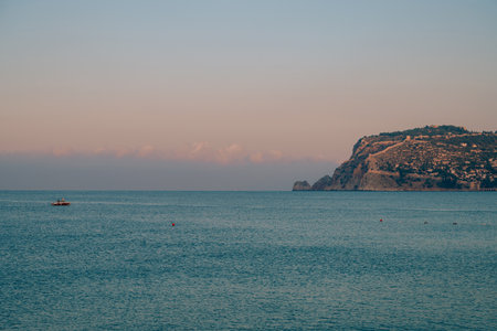 Beautiful sunrise scene on Alanya beach with view to famous Alanya island, in Turkeyの写真素材