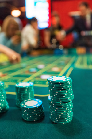 Poker chips on a poker table at the casinoの写真素材