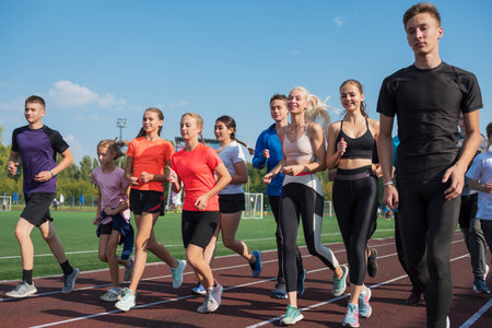 Group of young athletes training at the stadium. School gyms trainings or athleticsの写真素材