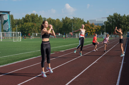 Group of young athletes training at the stadium. School gyms trainings or athleticsの写真素材