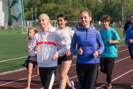 Group of young athletes training at the stadium. School gyms trainings or athleticsの写真素材
