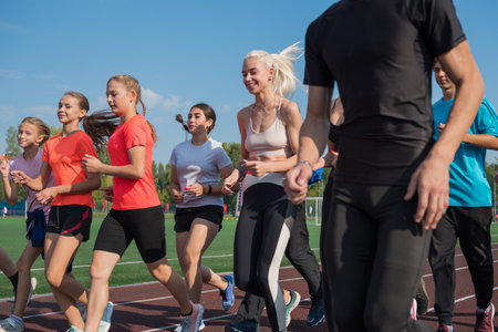 Group of young athletes training at the stadium. School gyms trainings or athletics