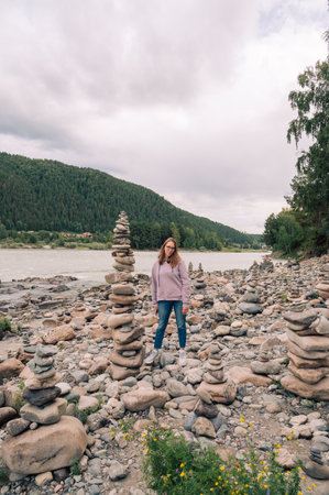 Woman at the river at summer day. Trip on Altai Mountains in Altai Republicの写真素材