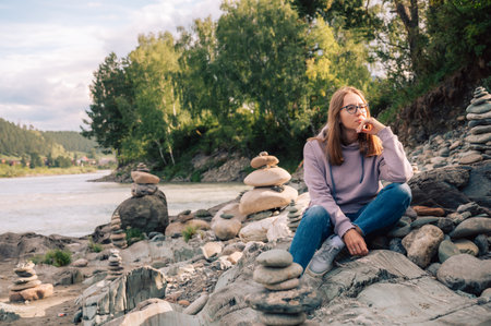 Woman at the river Katun at summer day. Trip on Altai Mountains in Altai Republicの写真素材