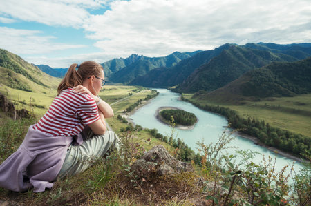 Woman at the river Katun at summer day. Trip on Altai Mountains in Altai Republicの写真素材