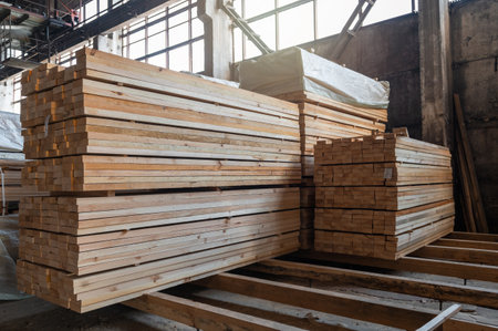 Stacked wooden planks close-up at lumber warehouse. Wood industry conceptの写真素材