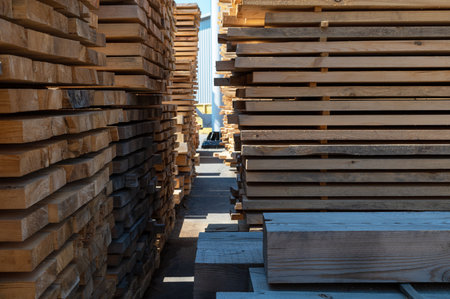 Stacked wooden planks close-up at lumber warehouse. Wood industry concept