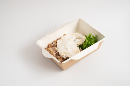 Takeout meals served in biodegradable containers, buckwheat with chicken, garnished with greens.の写真素材