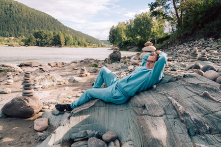 Man at the river Katun at summer day. Trip on Altai Mountains in Altai Republicの写真素材
