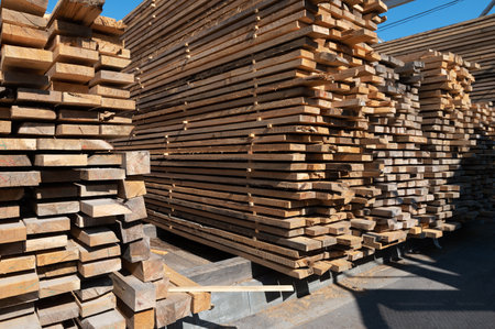 Stacked wooden planks close-up at lumber warehouse. Wood industry conceptの写真素材