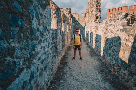 Man at fortress ruins of the historical Red Tower - Kizil Kule, in Alanya Castle, the famous touristic place.の写真素材