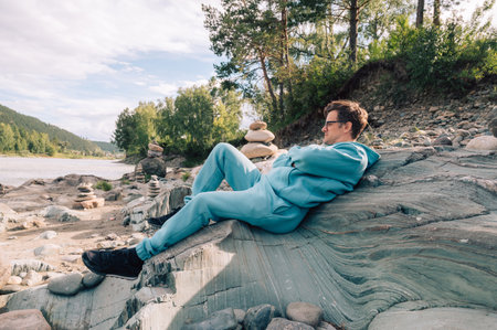 Man at the river Katun at summer day. Trip on Altai Mountains in Altai Republicの写真素材