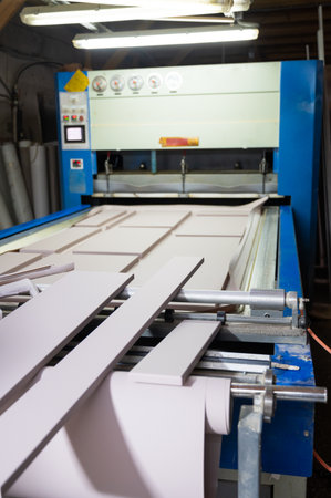 Grinding of wooden furniture panels on a machine. Furniture production conceptの写真素材